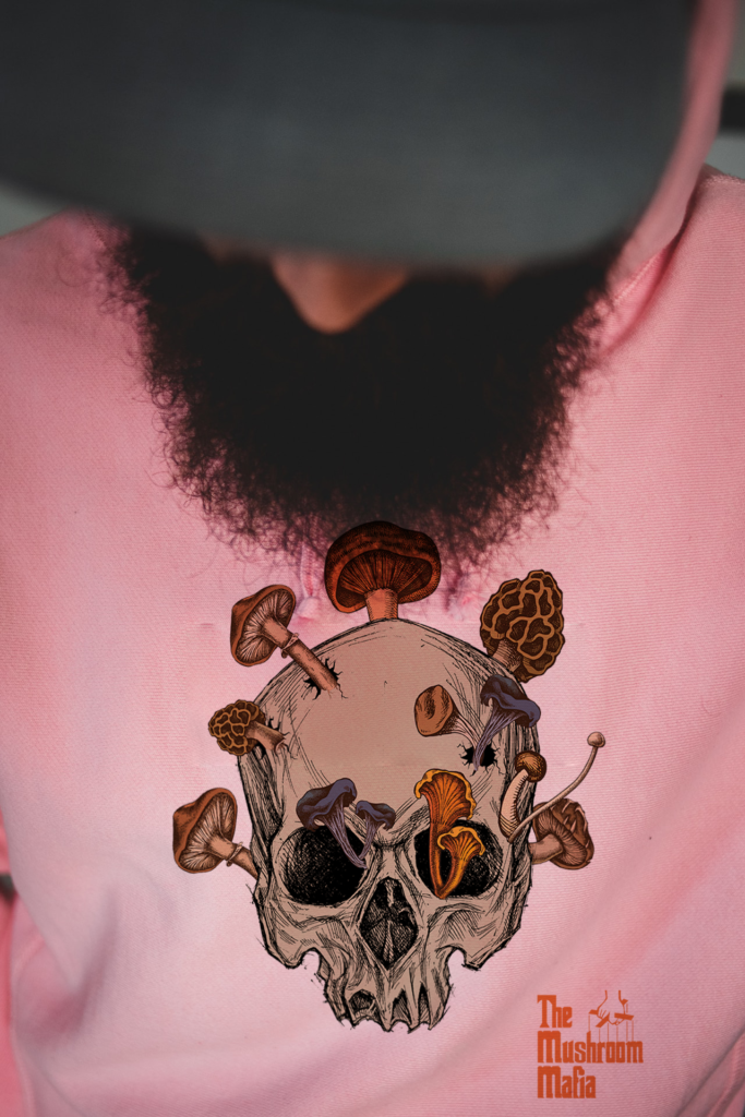 Skull with mushrooms growing from it on a pink hoodie